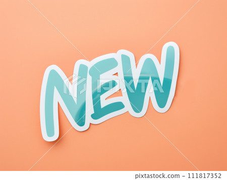 New, icon. New sign on a coral background. Phrase New on sticker on peach background. 111817352