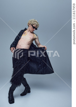 Expressive young man posing with naked torso and in trendy clothes against grey studio background. Self expression. Expressive young man posing with naked torso and in trendy clothes against grey studio background. Self expression. 111817959