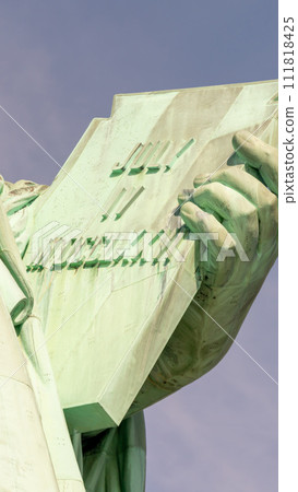 Declaration of Independence in the hand of the statue of liberty with the date of its adoption on July 4 111818425