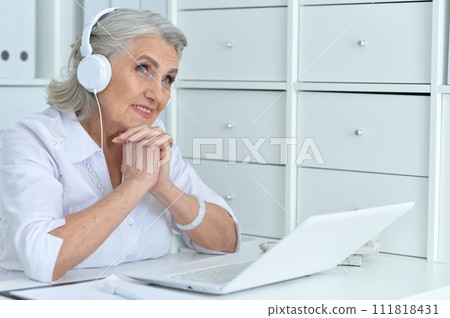 Portrait of senior woman working with laptop 111818431