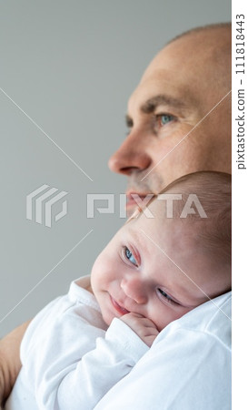 A man holds a baby in his arms. Parental care concept. A man holds a baby in his arms. Parental care concept. 111818443