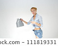 Woman holding canister of motor oil on light background 111819331