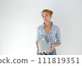 Woman holding canister of motor oil on light background 111819351