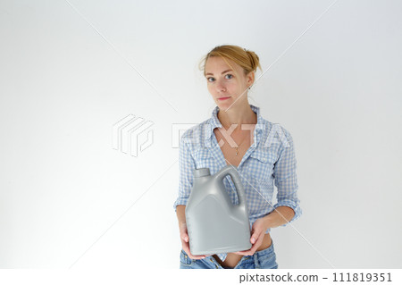 Woman holding canister of motor oil on light background 111819351