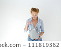 Woman holding canister of motor oil on light background 111819362