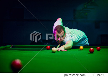 Dynamic shot of a player making shot, expressing energy and excitement for promoting billiards championship and local tournaments. Snooker game Dynamic shot of a player making shot, expressing energy and excitement for promoting billiards championship and local tournaments. Snooker game 111819790