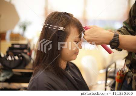 Male hairdresser cutting woman's hair Male hairdresser cutting woman's hair 111820100