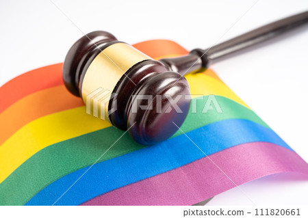 Gavel for judge lawyer on rainbow flag, symbol of LGBT pride month celebrate annual in June social of gay, lesbian, bisexual, transgender, human rights. Gavel for judge lawyer on rainbow flag, symbol of LGBT pride month celebrate annual in June social of gay, lesbian, bisexual, transgender, human rights. 111820661