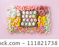 Easter sweet charcuterie board with chocolate eggs on pink background. Top view. 111821738