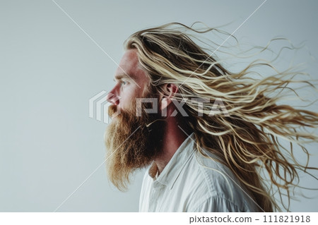 Profile portrait of handsome Caucasian bearded blonde man contented expression and healthy long hair 111821918