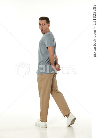 surprised guy looking at camera on white studio background 111822285