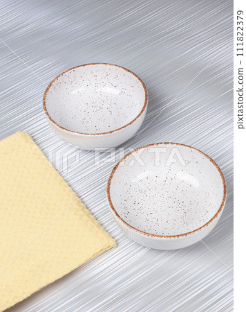 Ceramic clay plate with napkin on gray background Ceramic clay plate with napkin on gray background 111822379