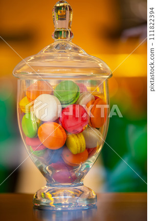 Glass vase with multi-colored marshmallow candies. 111822394