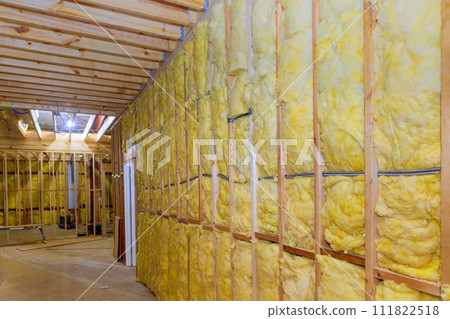 Thermal fiberglass insulation mineral rock wool installation to wall at new construction home 111822518