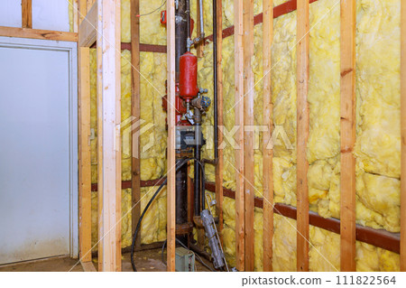 In construction of new home, fiberglass insulation mineral rock wool are installed to wall In construction of new home, fiberglass insulation mineral rock wool are installed to wall 111822564