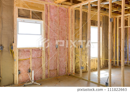 An installation of thermal fiberglass insulation mineral rock wool in new home An installation of thermal fiberglass insulation mineral rock wool in new home 111822663