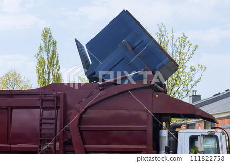 Waste is loaded into trash bin by municipal sanitation disposal service recycling garbage collector truck 111822758