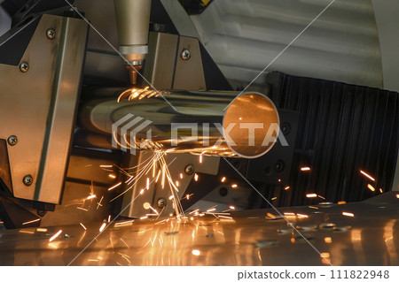 Close up scene the fiber laser cutting machine cut the stainless steel tube and sparkling light. Close up scene the fiber laser cutting machine cut the stainless steel tube and sparkling light. 111822948