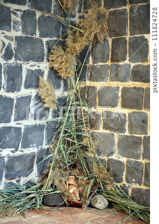 A baby Jesus figure on Christmas, Church of the Primacy of St Peter., Sea of Galilee, Tabgha, Israel 111824728