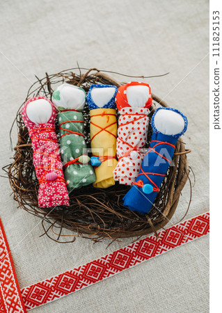 Handmade Motanka Dolls in a Nest for Good Luck. colorful handmade Motanka dolls, a traditional Slavic charm for luck and prosperity, with ethnic patterns. 111825153