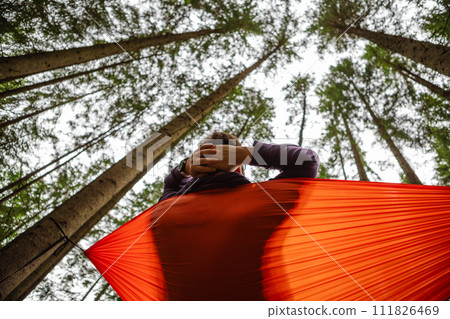 happy man in hammock in the middle of the forest happy man in hammock in the middle of the forest 111826469