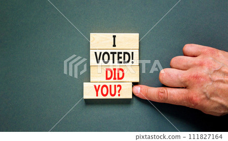 I voted. Did you symbol. Concept words I voted. Did you on beautiful wooden block. Beautiful grey table grey background. Voter hand. Business I voted. Did you concept. Copy space. 111827164