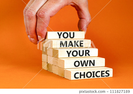 You make your own choice symbol. Concept words You make your own choice on wooden blocks. Beautiful orange background. Businessman hand. Business you make your own choice concept. Copy space. You make your own choice symbol. Concept words You make your own choice on wooden blocks. Beautiful orange background. Businessman hand. Business you make your own choice concept. Copy space. 111827189