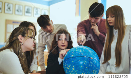 Students look at a globe of the starry sky in a classroom at school. Students look at a globe of the starry sky in a classroom at school. 111828705