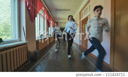 The students are running down the hallway of the school. 111828711