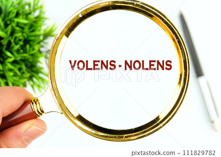 Willy - nilly latin expression volens-nolens (willing or unwilling) written through a magnifying glass on a white background Willy - nilly latin expression volens-nolens (willing or unwilling) written through a magnifying glass on a white background 111829782