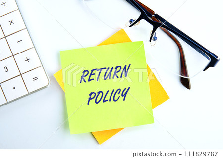 Return Policy written on a yellow sticker on a white background 111829787