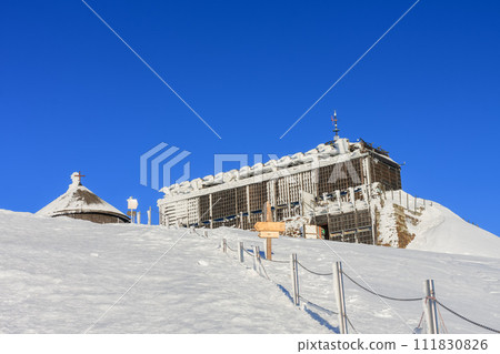 Wooden building of new post office with souvenirs and postcards in snezka, mountain on the border between Czech Republic and Poland, winter, morning time. Wooden building of new post office with souvenirs and postcards in snezka, mountain on the border between Czech Republic and Poland, winter, morning time. 111830826