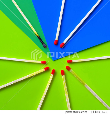 Success, defeat, achievement. The concept of happiness. Matches on a yellow background. Burnt dark match among normal matches. Burning match fire to its neighbors, a metaphor for ideas and inspiration 111831622