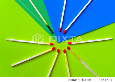 Success, defeat, achievement. The concept of happiness. Matches on a yellow background. Burnt dark match among normal matches. Burning match fire to its neighbors, a metaphor for ideas and inspiration Success, defeat, achievement. The concept of happiness. Matches on a yellow background. Burnt dark match among normal matches. Burning match fire to its neighbors, a metaphor for ideas and inspiration 111831625