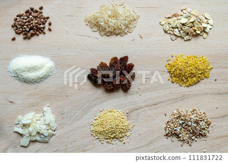 Assorted cereal grain porridge seeds set on a wooden background: buckwheat, rice, semolina, wheat, couscous, oatmeal Assorted cereal grain porridge seeds set on a wooden background: buckwheat, rice, semolina, wheat, couscous, oatmeal 111831722