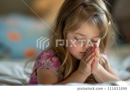 AI-generated content. A seven-year-old girl with blond hair sits indoors with her eyes closed and her hands clenched in a pose reminiscent of prayer 111831899