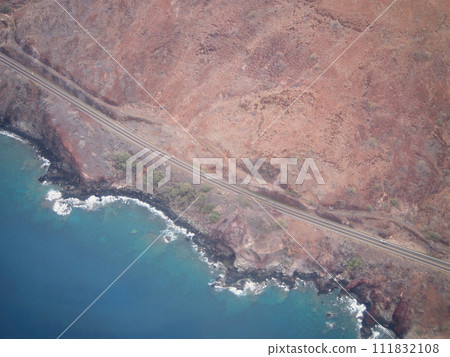 Aerial view of scenic road along day coast of Maui 111832108