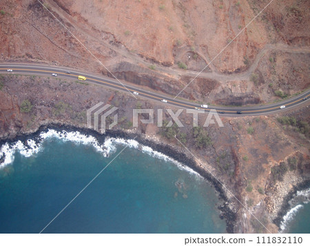 Aerial view of scenic road with cars driving along the coast of Maui Aerial view of scenic road with cars driving along the coast of Maui 111832110