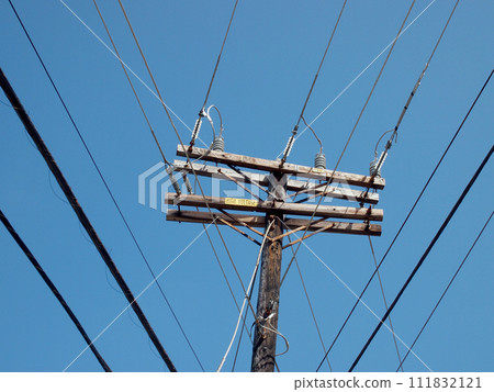 High Voltage Power Lines intersect at a wooden power pole 111832121