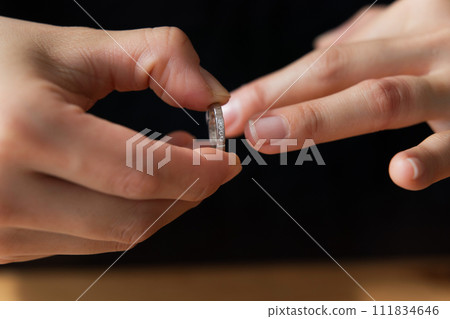 Photo of hand removing ring Photo of hand removing ring 111834646