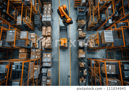 Overhead view of a bright orange forklift moving along a narrow aisle in a densely packed warehouse, showcasing the precision and order of modern logistics. 111834945