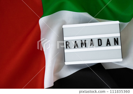 Congratulations Lightbox with text RAMADAN waving UAE flag on background concept. Greeting card advertisement. Commemoration Day Muslim Blessed holy month holiday Congratulations Lightbox with text RAMADAN waving UAE flag on background concept. Greeting card advertisement. Commemoration Day Muslim Blessed holy month holiday 111835360