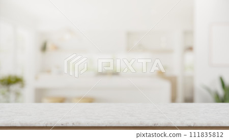 A copy space on a white marble tabletop with a blurred background of a modern white kitchen. 111835812