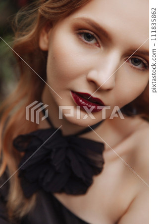 Close-up portrait of beautiful woman with bright make-up and dark red lips 111835862