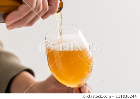 beer pouring into a glass beer pouring into a glass 111836244