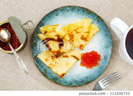 On plate - ruddy soft pancakes with spoonful fresh-grain caviar On plate - ruddy soft pancakes with spoonful fresh-grain caviar 111836733