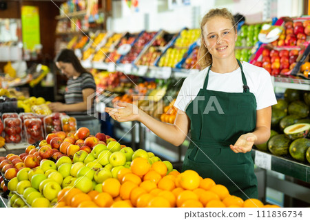 Portrait of a smiling girl who works part-time in a store as a trainee saleswoman Portrait of a smiling girl who works part-time in a store as a trainee saleswoman 111836734
