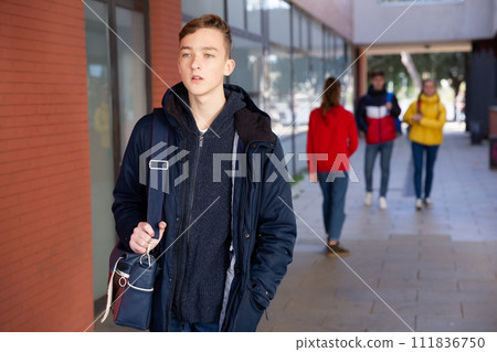 Teenager walking in the street 111836750