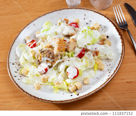 Variation of Caesar salad with chicken, lettuce mix and crackers Variation of Caesar salad with chicken, lettuce mix and crackers 111837152