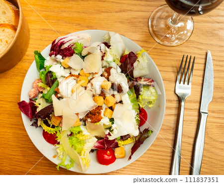 Caesar salad with chicken and parmesan cheese 111837351